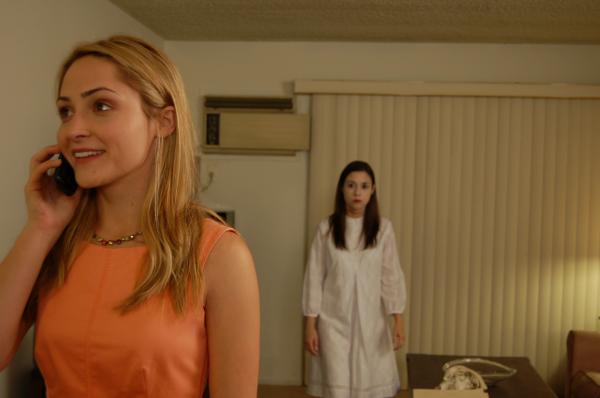 Kim is speaking to her love interest Tom, unaware that the ghost is watching her.